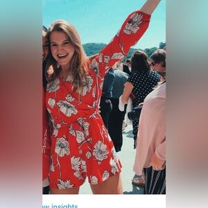 Red and white long sleeve romper.